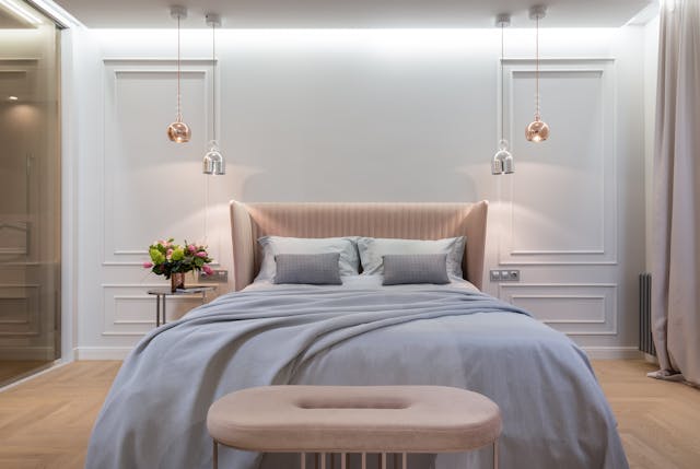 Afurnished bedroom with decorative lights beside the bed